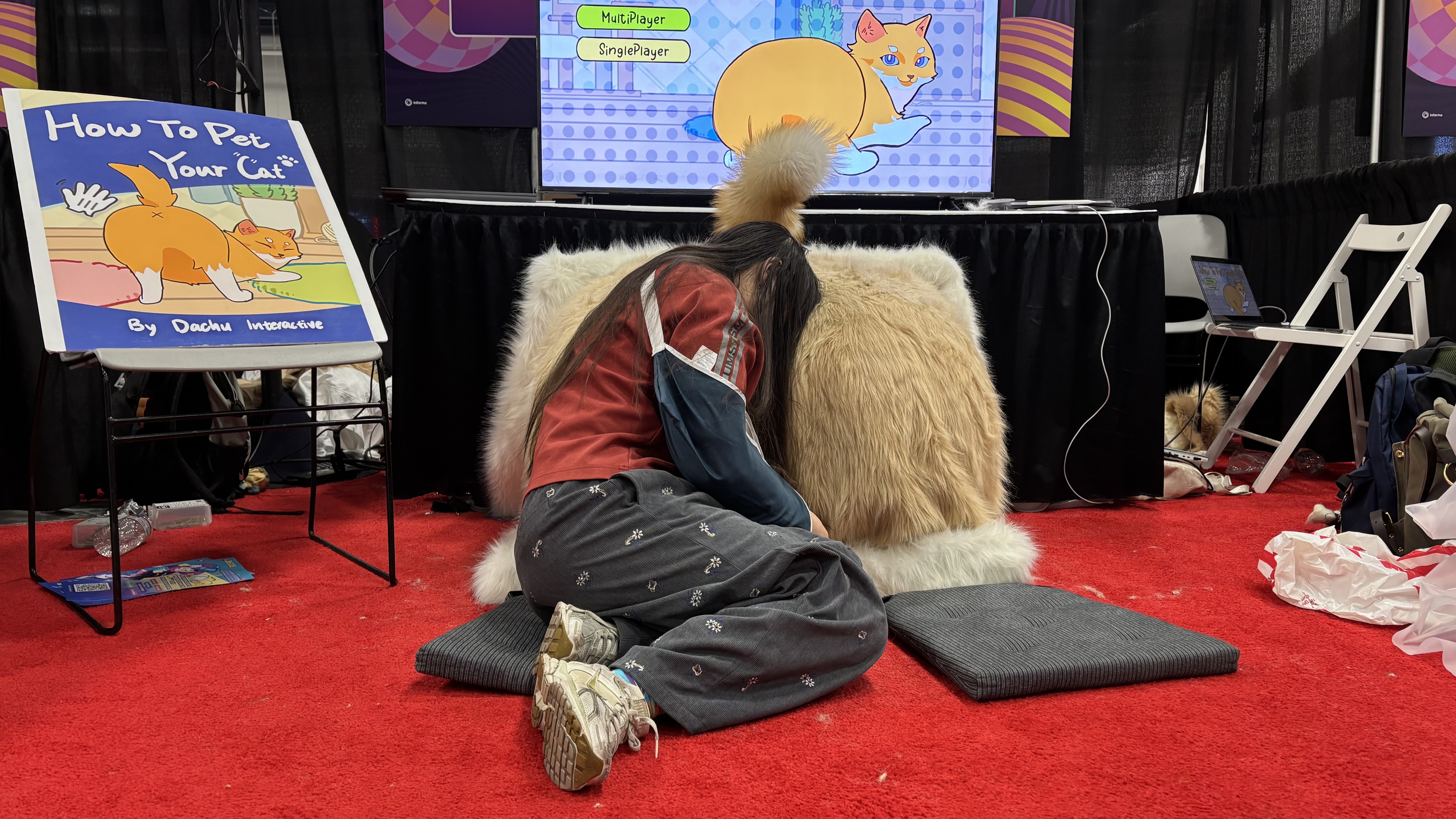 Player using the How to Pet Your Cat plush controller at GDC