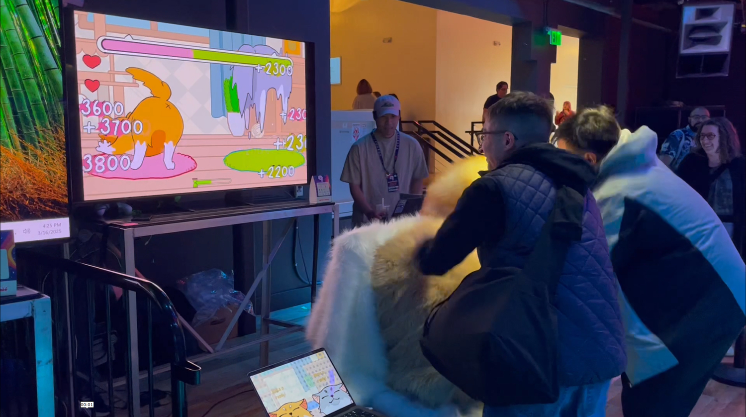 Players petting the plush cat controller together